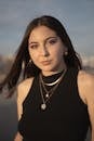 A woman with long hair and a necklace